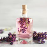 Bottle with lavender oil and flowers